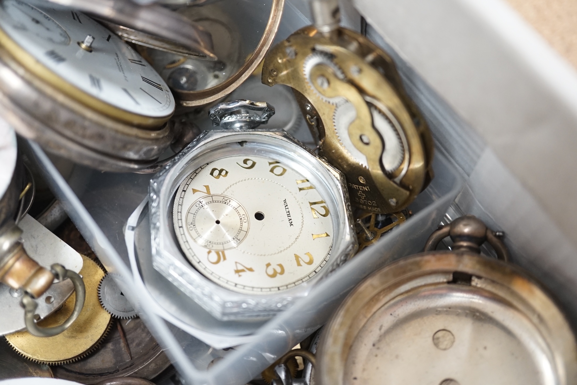 A collection of pocket watch cases (some silver), movements, dials and parts. Condition - poor